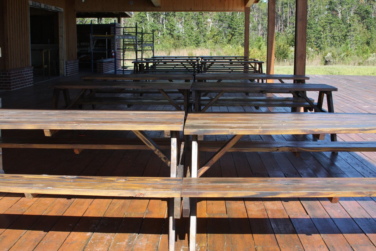 Long dining tables under a covered pavilion